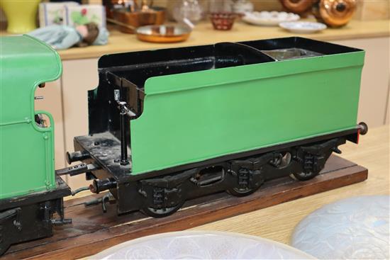 A 3.5 inch gauge 4-4-2 live steam locomotive and tender on wood stand, loco 27in. tender 18in.